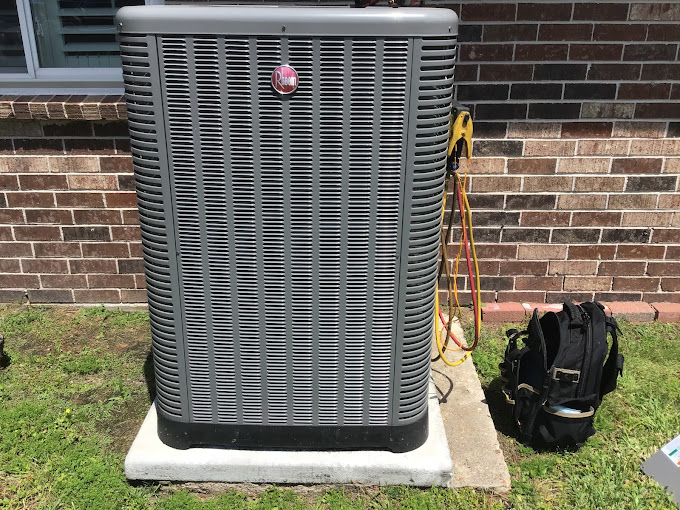Newly serviced residential AC condenser on a concrete pad at a Texas Heatwave repair job