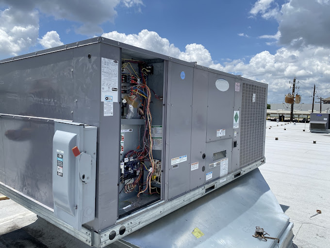 Commercial rooftop packaged HVAC unit opened for service by Texas Heatwave in Houston